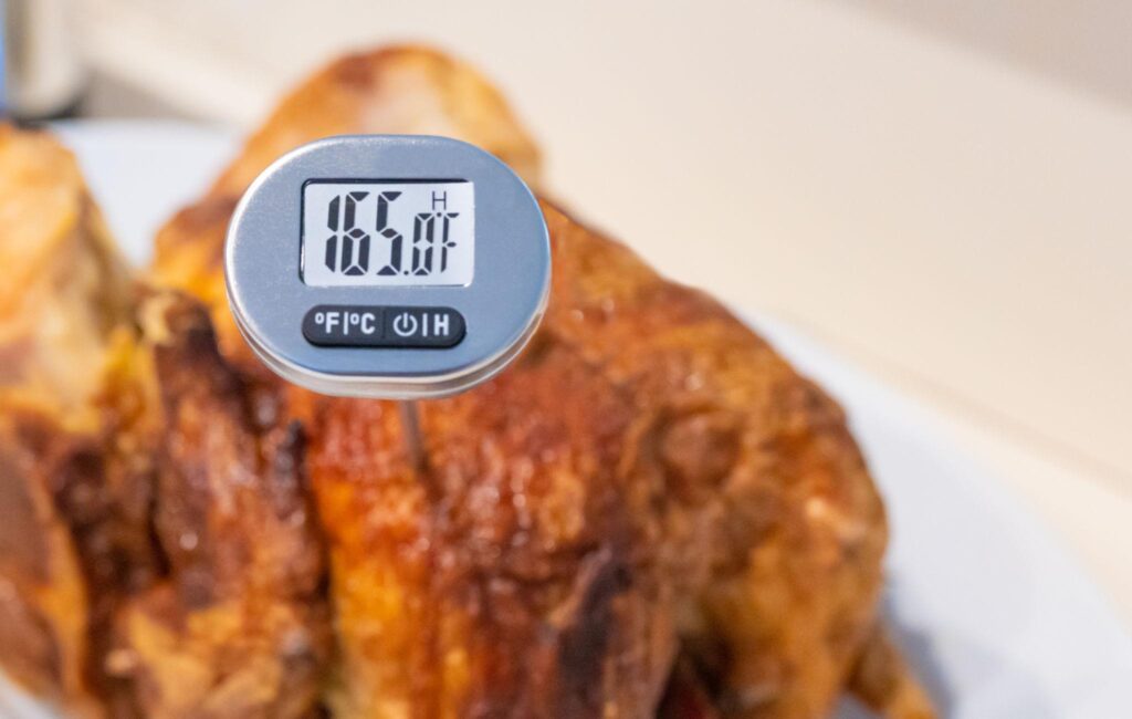 Checking internal temperature of air fryer chicken breast at 165°F