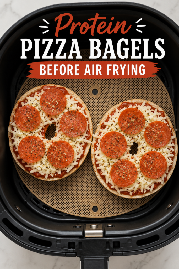 Uncooked Air Fryer Protein Pizza Bagels with mozzarella cheese and turkey pepperoni inside an air fryer basket.